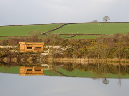 Bird hide reflection at Meeth Quarry