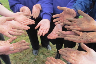 Wildlife Champions hands at conference after making seed bombs