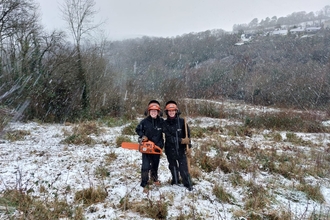 DWT volunteers in the snow clearing scrub