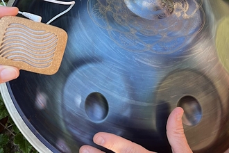 metal handpan with dents that when drummed create different musical notes