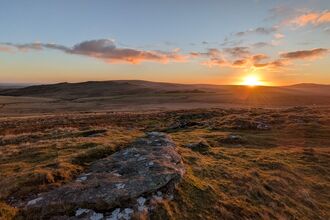 Stunning sun rising beyond the hills of Dartmoor