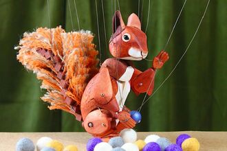 A red squirrel puppet ready to tell you a story