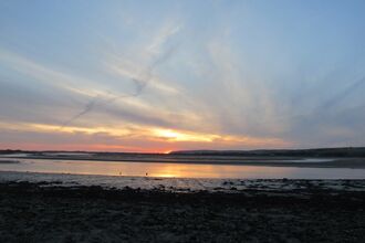 Sunset over the quay with the tide out