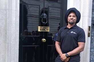 Randy stood proudly in front of the black door of 10 Downing Street