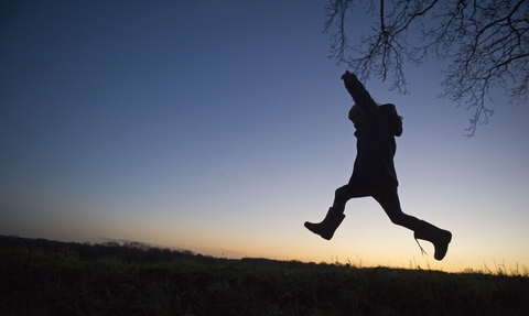 Child leaping against sky-line