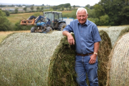 Cyril Cole with green hay bale