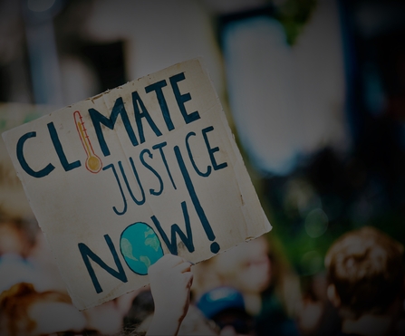 Sign reading climate justice now