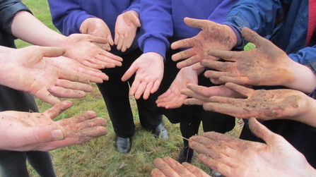 Wildlife Champions hands at conference after making seed bombs