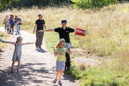Staff and children running through field