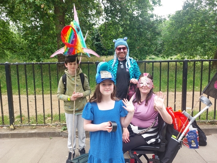 Two adults and children dressed in marine costumes