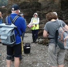 Debbie standing facing a group of onlookers and leading the Shoresearch session
