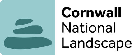 It says Cornwall National Landscape with the three stacked pebbles to the side