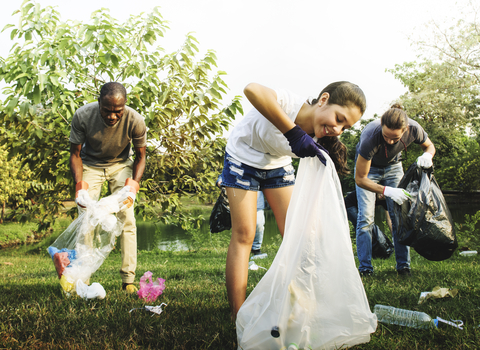 A group of people litter picking in a green space